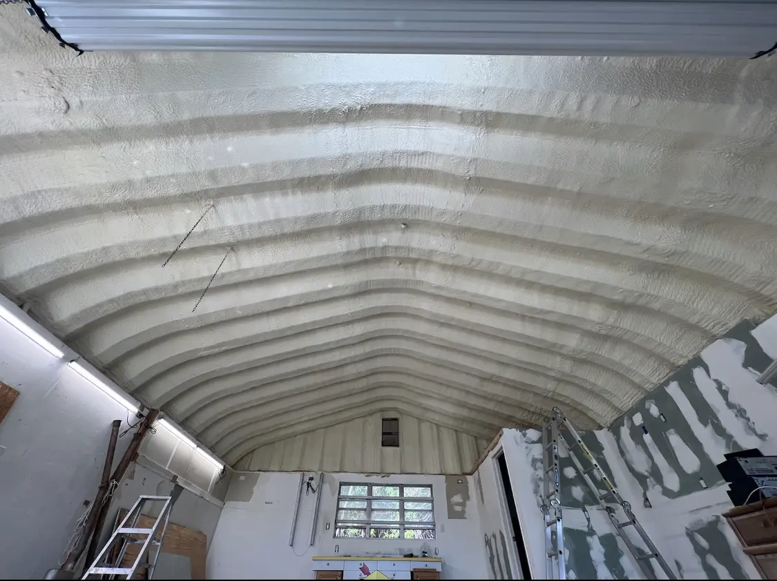 Spray polyurethane foam applied to the underside of a metal roof deck in Exeter